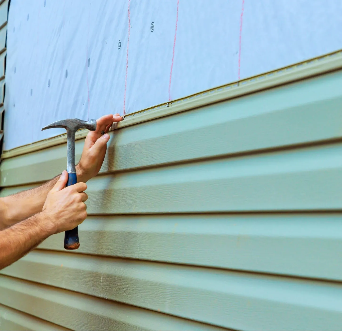 a person installing vinyl siding